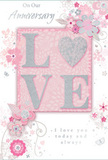 This anniversary card presents a tender celebration of lasting romance, its design unfolding in a harmony of soft pastel pinks and silvery greys, much like a subtle bouquet chosen from a Guildford florist tucked just off North Street. At the centre, the word LOVE appears in raised, glitter-touched letters, with the letter O beautifully replaced by a shimmering silver heart. This heart has a textured, lightly embossed surface, giving it a jewellery-like gleam when the card is tilted under the light. The surrounding letters are softly glittered, creating a tactile, almost velvety finish against the smooth card stock. Around this focal word, delicate blossoms in blush and mauve unfurl in an almost watercolour style, their petals and leaves flowing outward in gentle arcs that echo the curves of hand-tied anniversary arrangements delivered around Stoughton or Jacob's Well. Fine swirls, tiny petals, and subtle butterflies weave through the design, adding a sense of movement and quiet whimsy, as if the flowers were stirred by a light spring breeze. The background is a pale, comforting pink, allowing the floral details and silver accents to stand out without feeling busy. Elegant script near the top reads On Our Anniversary, while the phrase I love you today and always sits below, both set in a refined, flowing type that feels personal yet timeless. The overall impression is soft and intimate, a paper keepsake that mirrors the emotion of receiving a thoughtfully arranged anniversary bouquet in Guildford, designed to capture shared memories and the promise of many more years together.